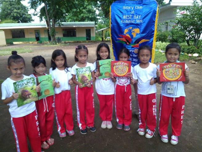 School children with picture books donated by the Rotary Club of West Bay, Laguna